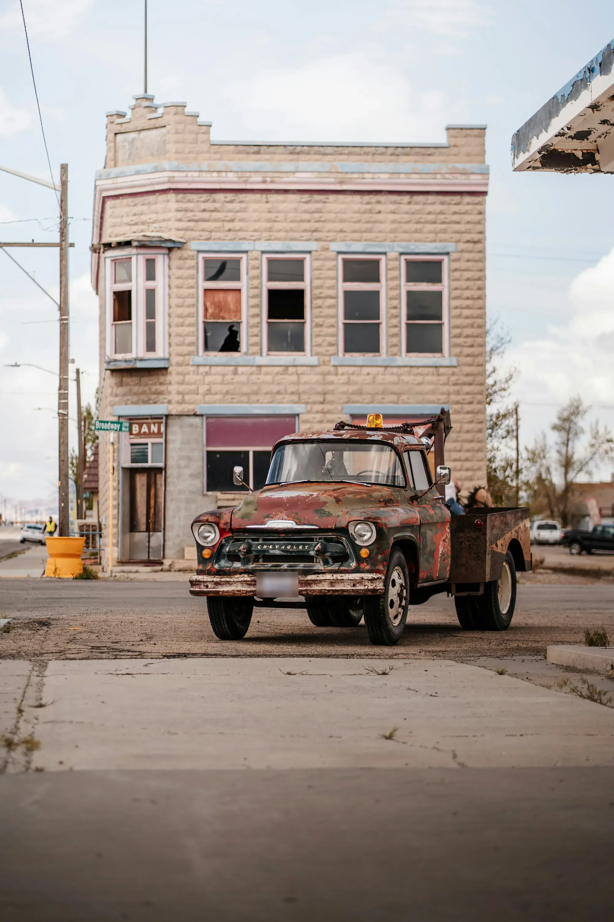 Vintage wrecker tow truck parked on a quiet downtown street
